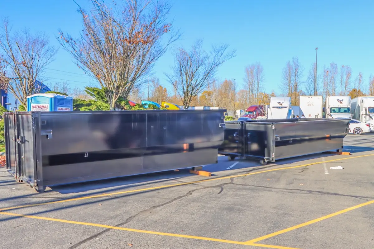 Professional dumpster rental service with roll-off container on residential driveway in Humboldt